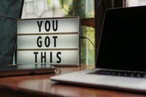 Motivational light box sign 'You Got This' next to laptop for workspace inspiration