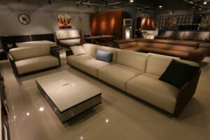 Spacious modern living room showcasing a stylish sectional sofa in neutral tones, complemented by a sleek coffee table and contemporary decor, perfect for comfortable gatherings.