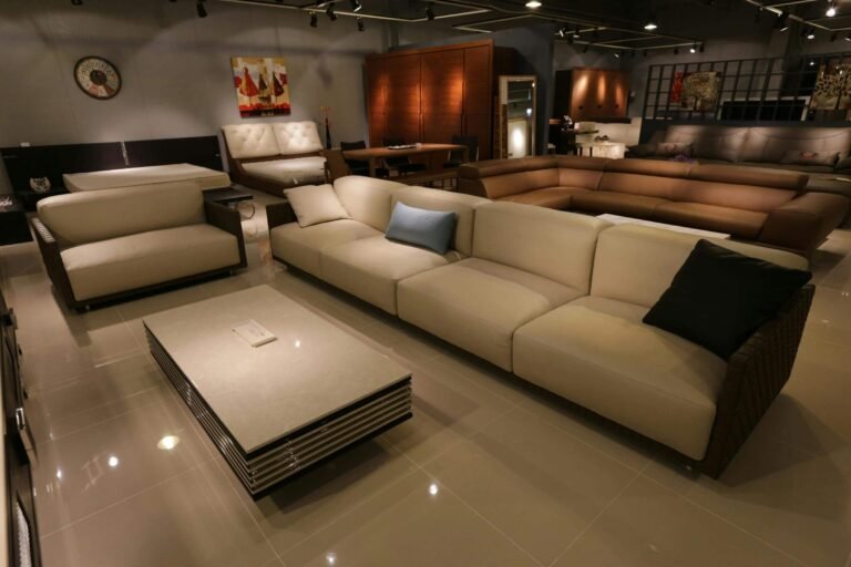 Spacious modern living room showcasing a stylish sectional sofa in neutral tones, complemented by a sleek coffee table and contemporary decor, perfect for comfortable gatherings.