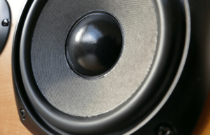 Close-up image of a high-quality subwoofer speaker, showcasing its detailed cone and design, perfect for delivering rich bass in home audio systems.