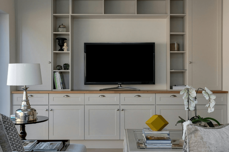 Elegant living room setup featuring a sleek, modern TV integrated into custom built-in shelving, offering both style and functionality for a connected home.