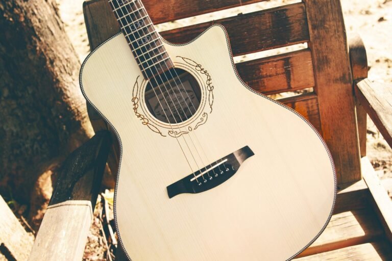 Acoustic guitar resting on wooden chair