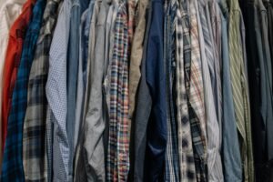 Closet rack filled with various patterned and colored shirts