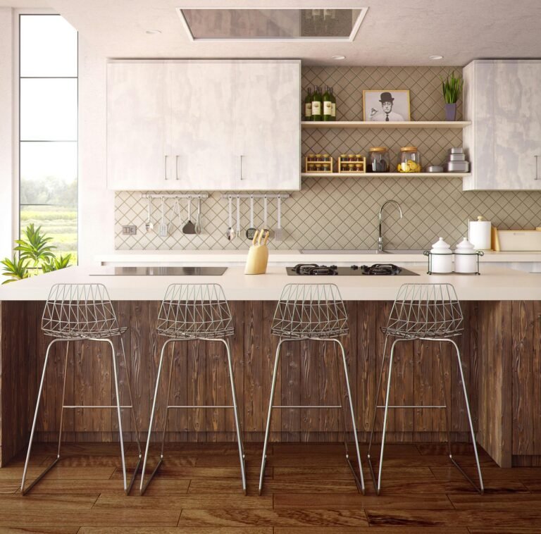 Modern kitchen with white cabinets, beige diamond-patterned backsplash, wooden island, and four wire frame bar stools. The kitchen features open shelving, hanging utensils, and a tall window providing natural light.