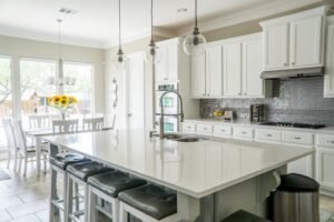 White kitchen with stainless steel appliances and a spacious layout