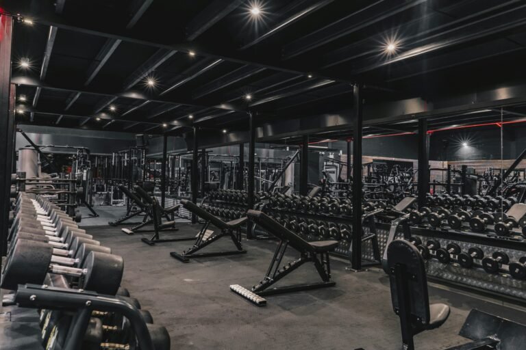 Large fitness center lined with cardio machines and ample space.