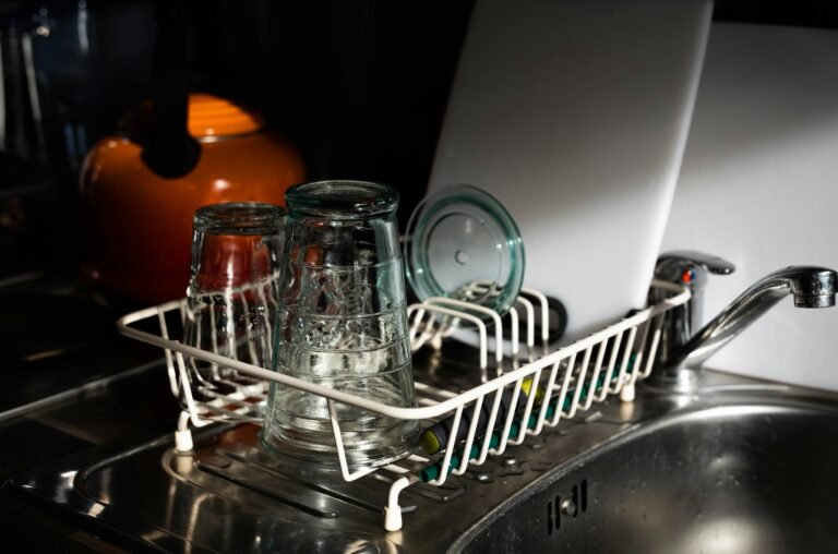 Dishwasher rack holding newly washed plates and cups.