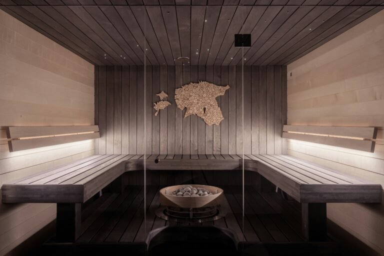 All-cedar sauna room with benches and soft ambient lighting.