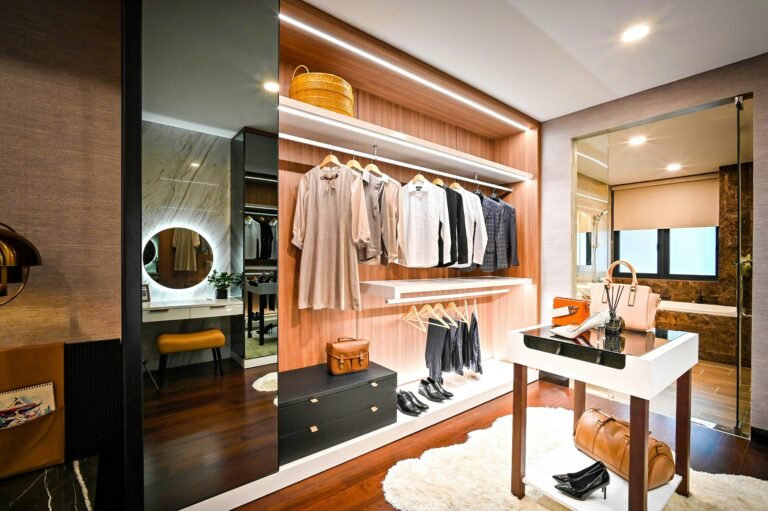 Organized walk-in closet with shelves and clothing.