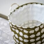 Lightweight fabric basket with white polka dots on a patterned floor.
