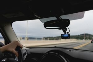 Interior dashboard perspective looking out a windshield while driving.