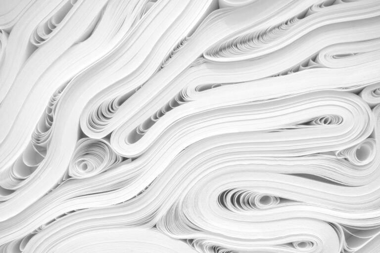 Abstract arrangement of rolled white paper creating layered curves