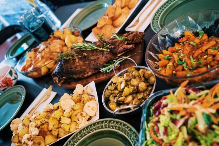 Selection of colorful dishes laid out on a catering buffet.