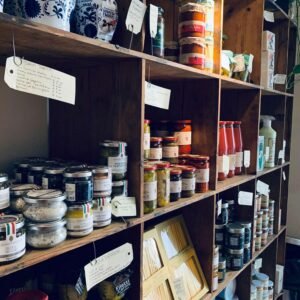 Pantry shelf stocked with jars of spices and ingredients