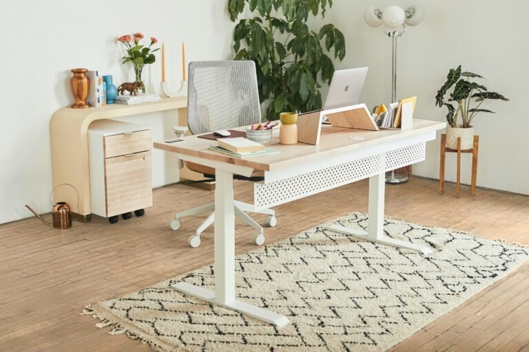 Streamlined workstation with adjustable-height desk in a light room.