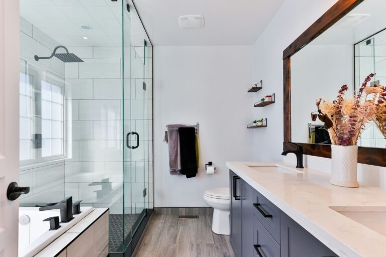 Modern bathroom with glass shower enclosure and bright lighting