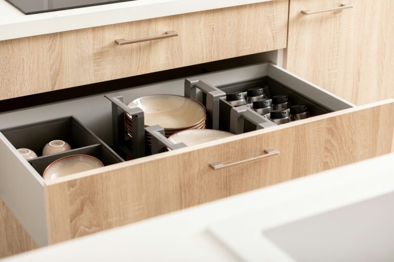 Open kitchen drawer holding neatly arranged utensils