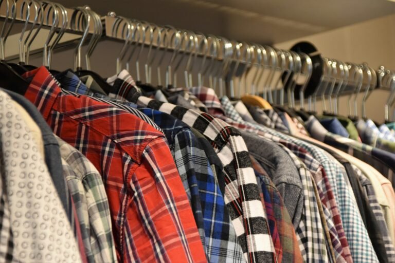 Clothes hanging on a rack, showcasing multiple patterns and fabrics