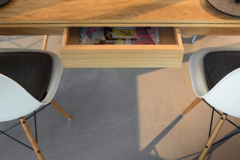 Wooden table with modern chairs in a minimalist space
