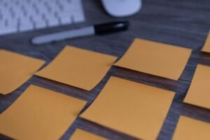 Multiple sticky notes spread on a wooden desktop