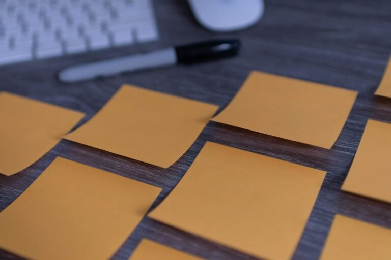 Multiple sticky notes spread on a wooden desktop