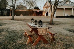 Wooden picnic table set on grassy lawn, ready for casual gatherings.