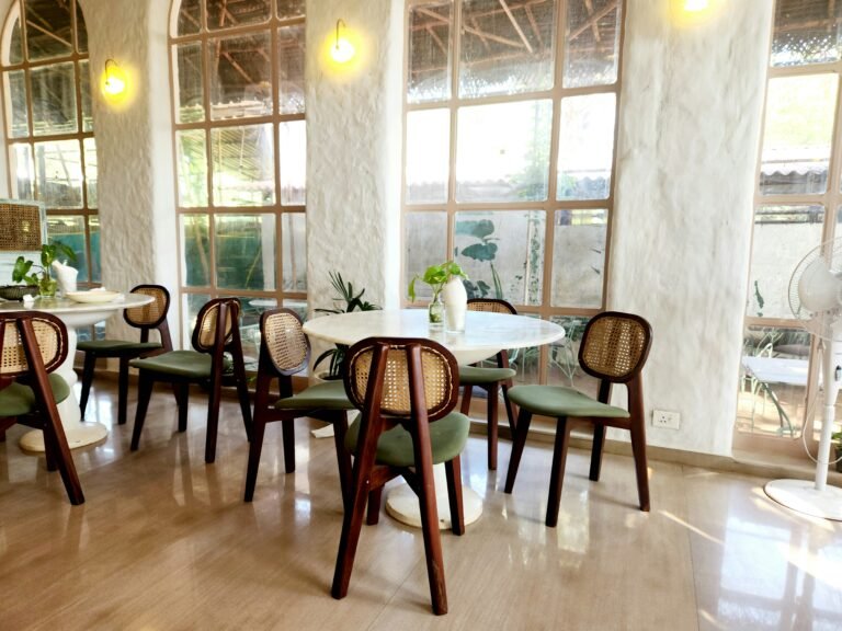 Sleek café interior with wooden chairs and table settings.