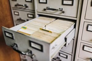 Open drawer in a metal filing cabinet revealing stored records.