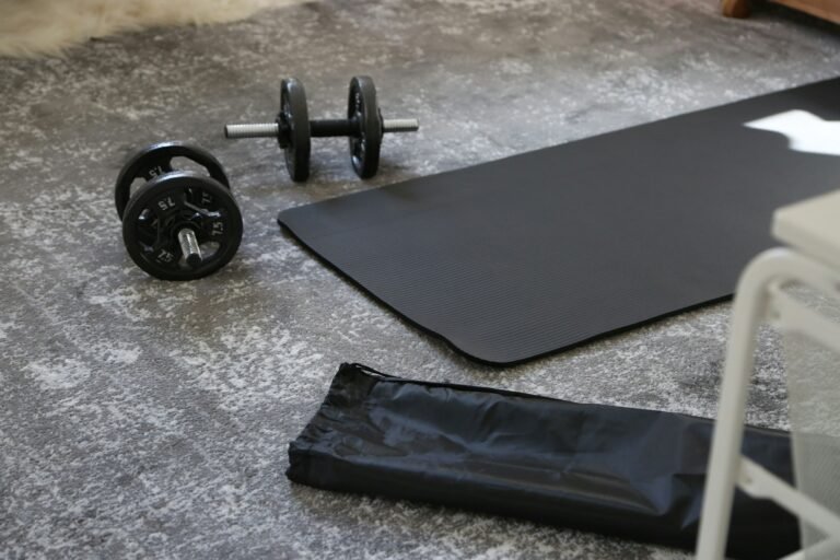 Dumbbells and exercise mat laid out in a home gym space.