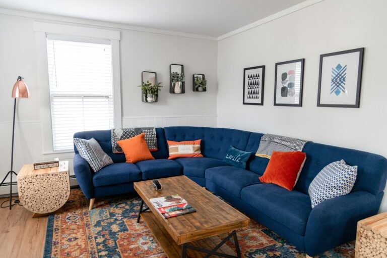 Stylish living room focused on a large blue sectional couch.