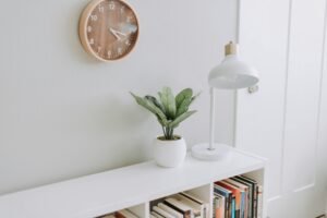 Minimalist shelf with clock, lamp, and greenery