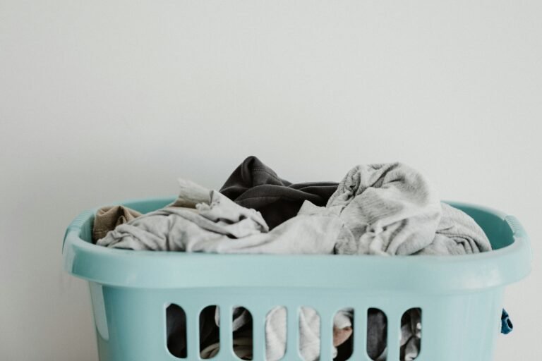 Overfilled laundry basket with clothes in neutral shades