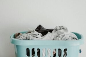 Overflowing laundry basket filled with clothing.