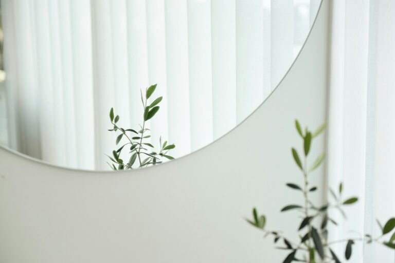 Bright, modern workspace featuring curved glass decor and greenery.