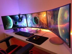 Curved multi-monitor gaming station with LED lights