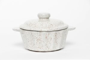 Speckled ceramic lidded pot with a simple, handcrafted style.