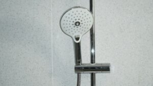 Sleek shower head and minimalist bathroom tile design.