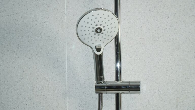 Sleek shower head and minimalist bathroom tile design.