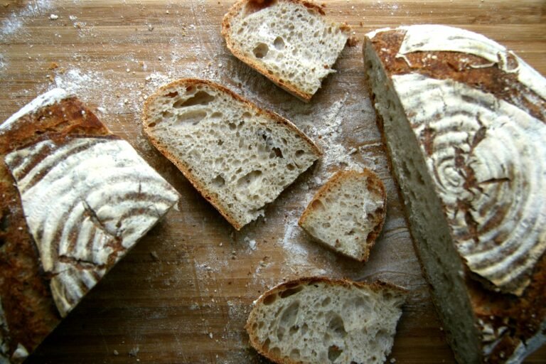Freshly baked artisan bread slices on a wooden board.