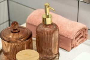 Modern bathroom vanity with decorative dispensers and towels