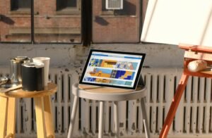 Laptop stand with painting materials in a creative workspace
