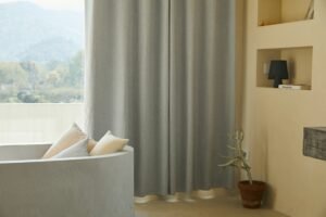 Bright living area with pale curtains and neutral seating