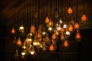 Assorted hanging pendant lights, each glowing warmly