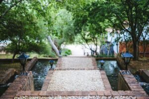Outdoor walkway over garden water feature