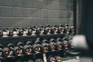 Rows of dumbbells in a gym setting