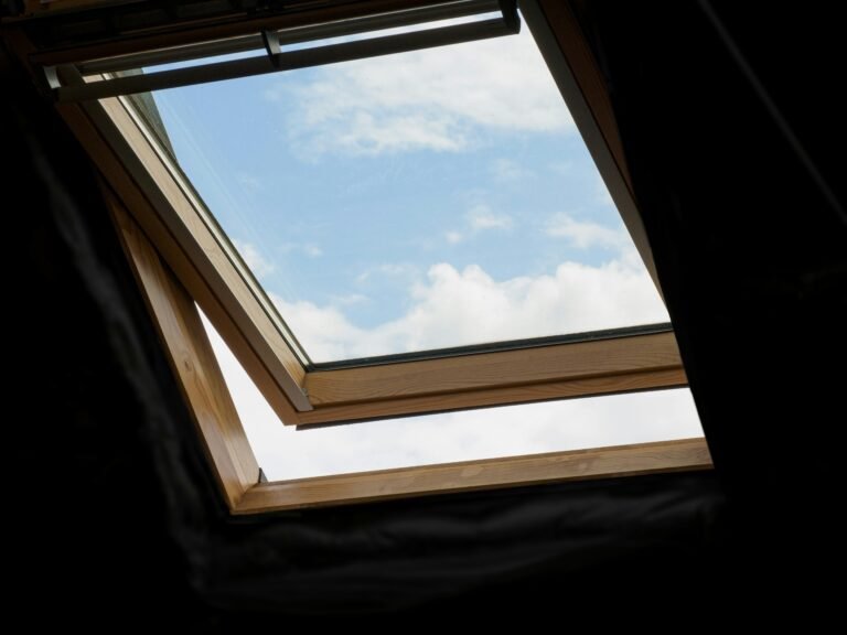 Sunlit skylight revealing a clear blue sky view.