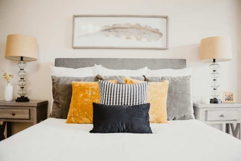 Neutral-toned bedroom with decorative pillows and lamps